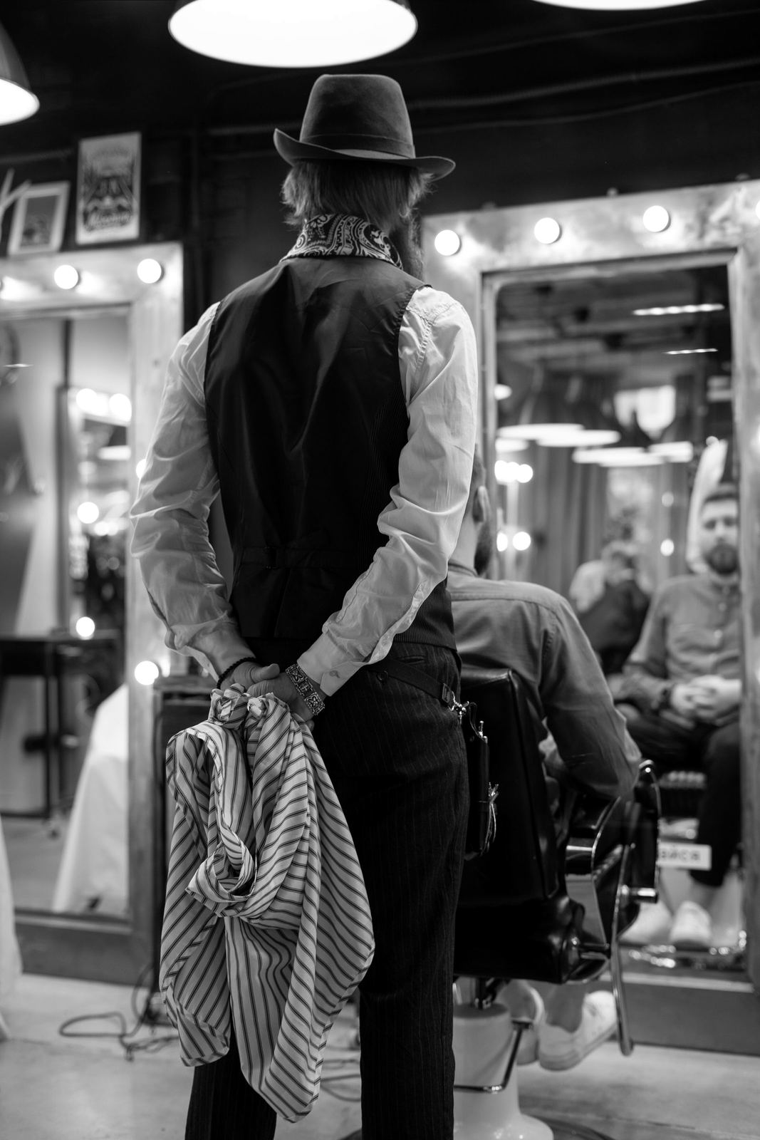 Barber checking a cut in the mirror