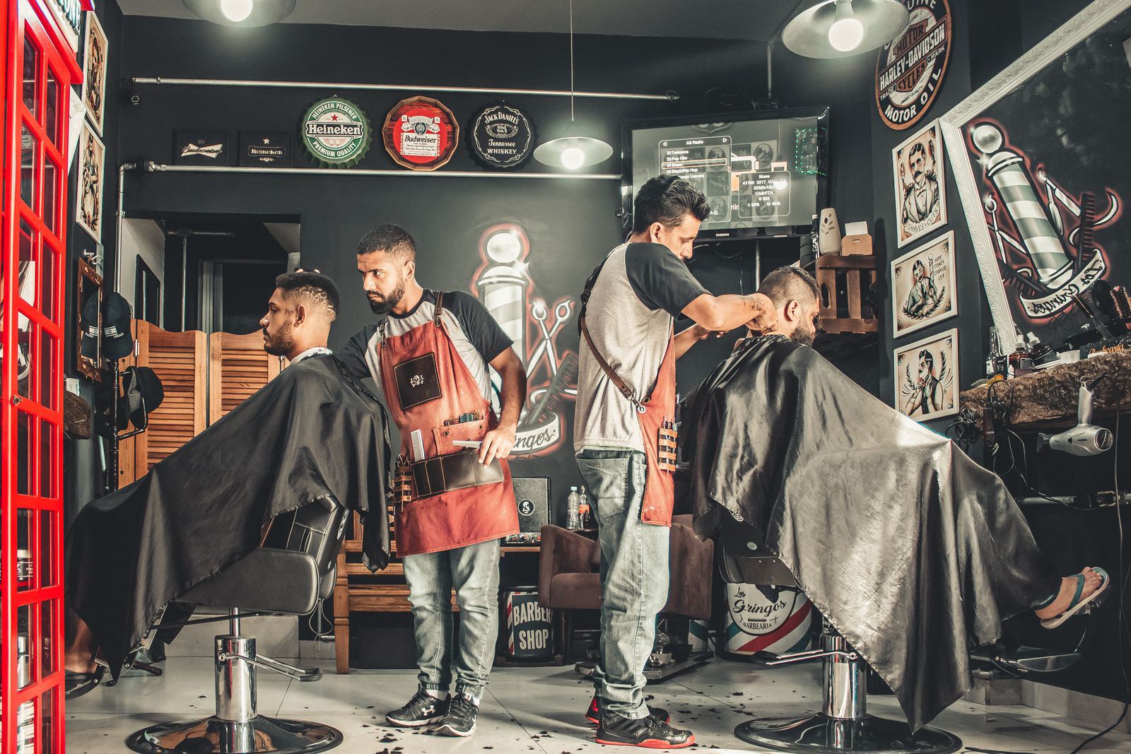 Two barbers working the floor of the shop