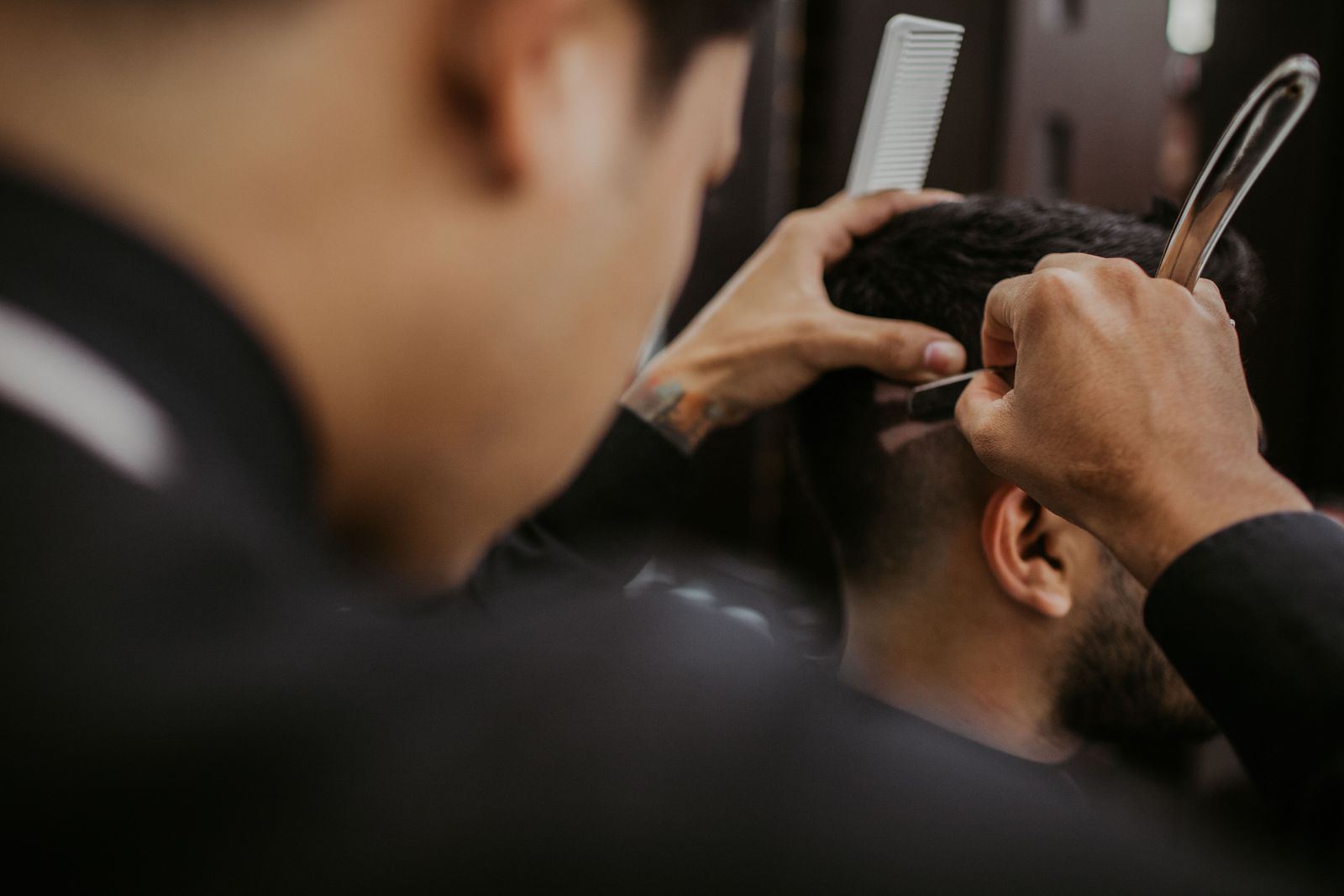 Barber working through the back of a cut