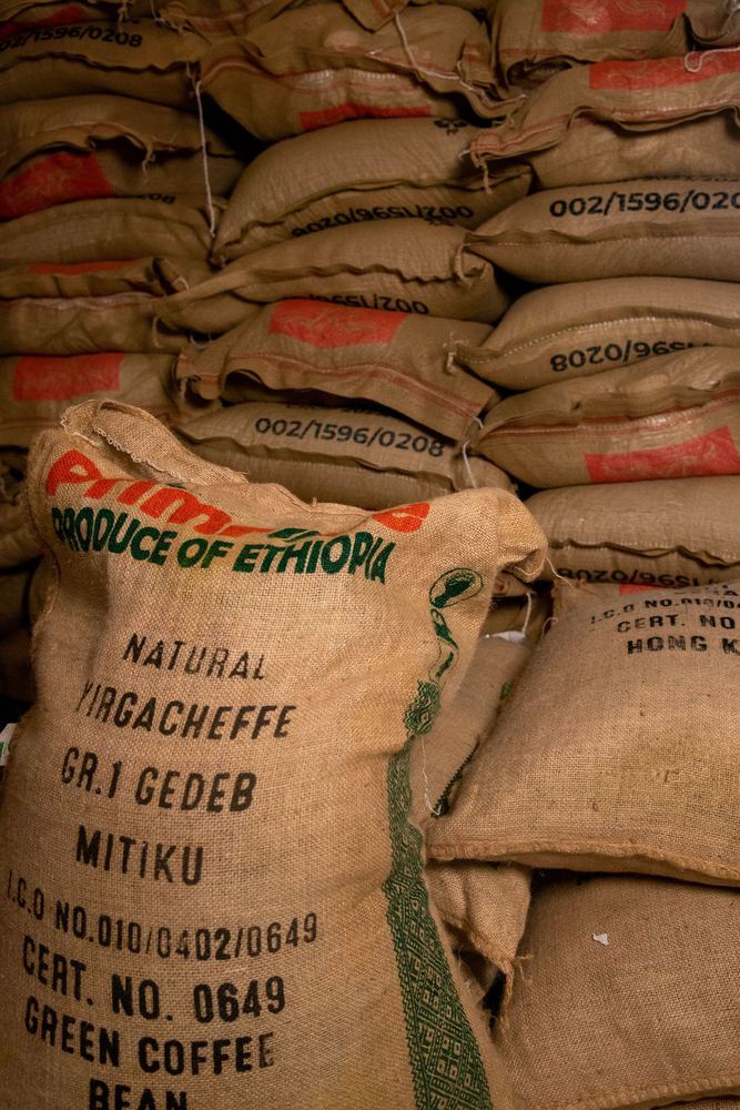 Stacked burlap sacks of green coffee