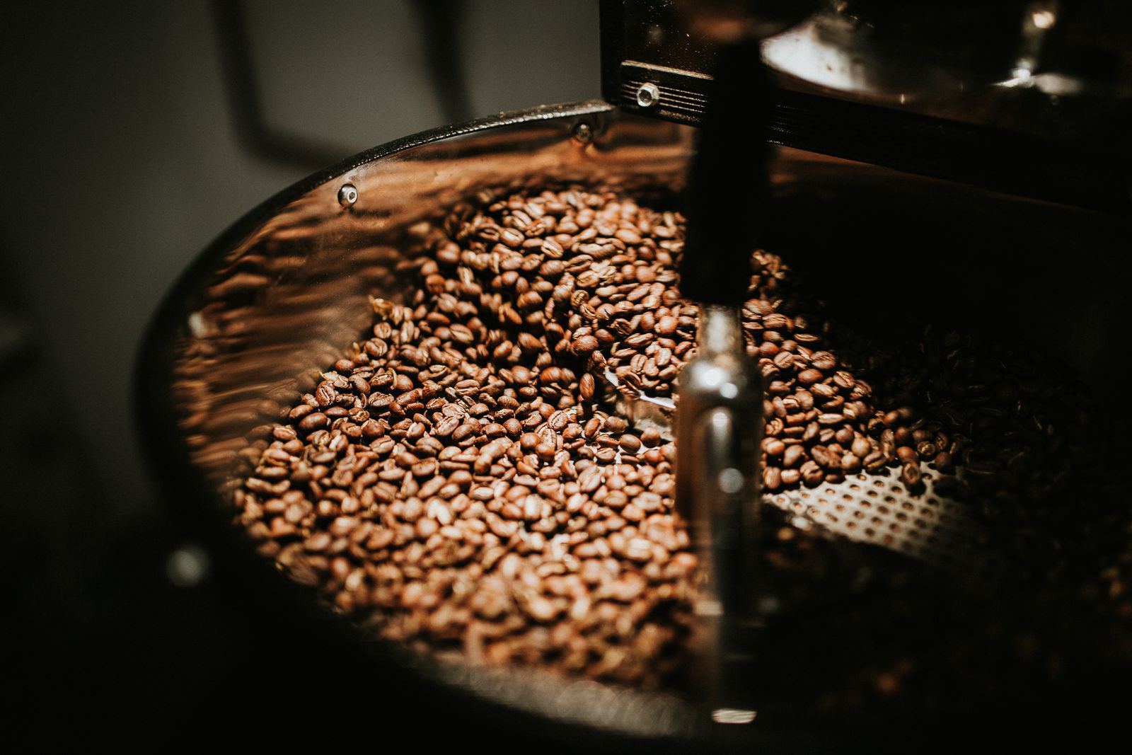 Coffee beans tumbling inside the roaster drum