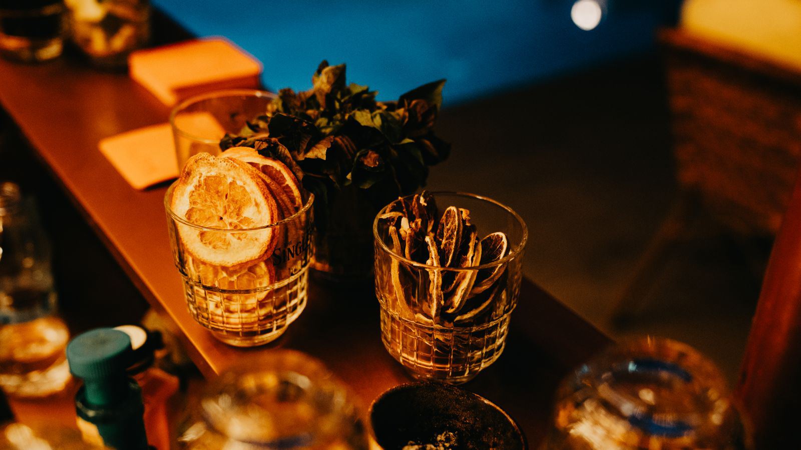 The amber-lit bar counter at ORO