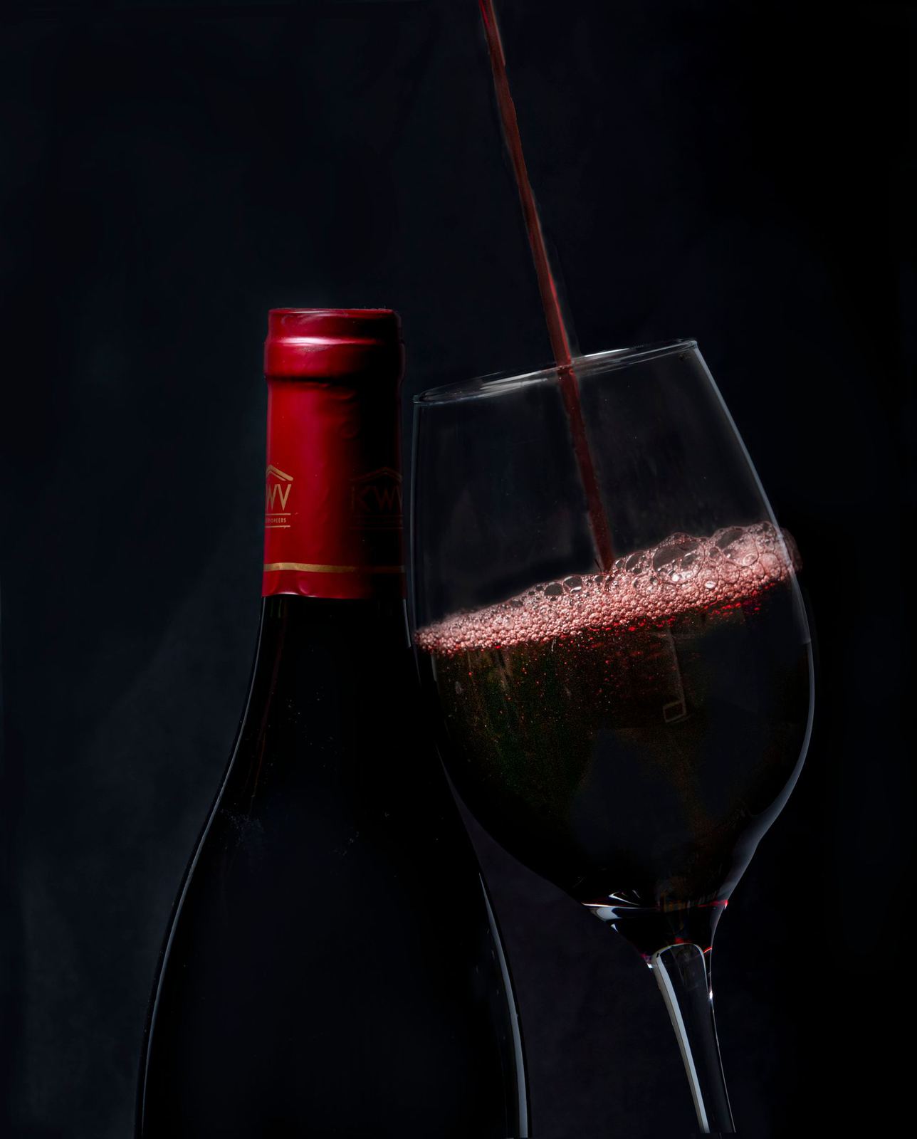 Red wine being poured into a glass