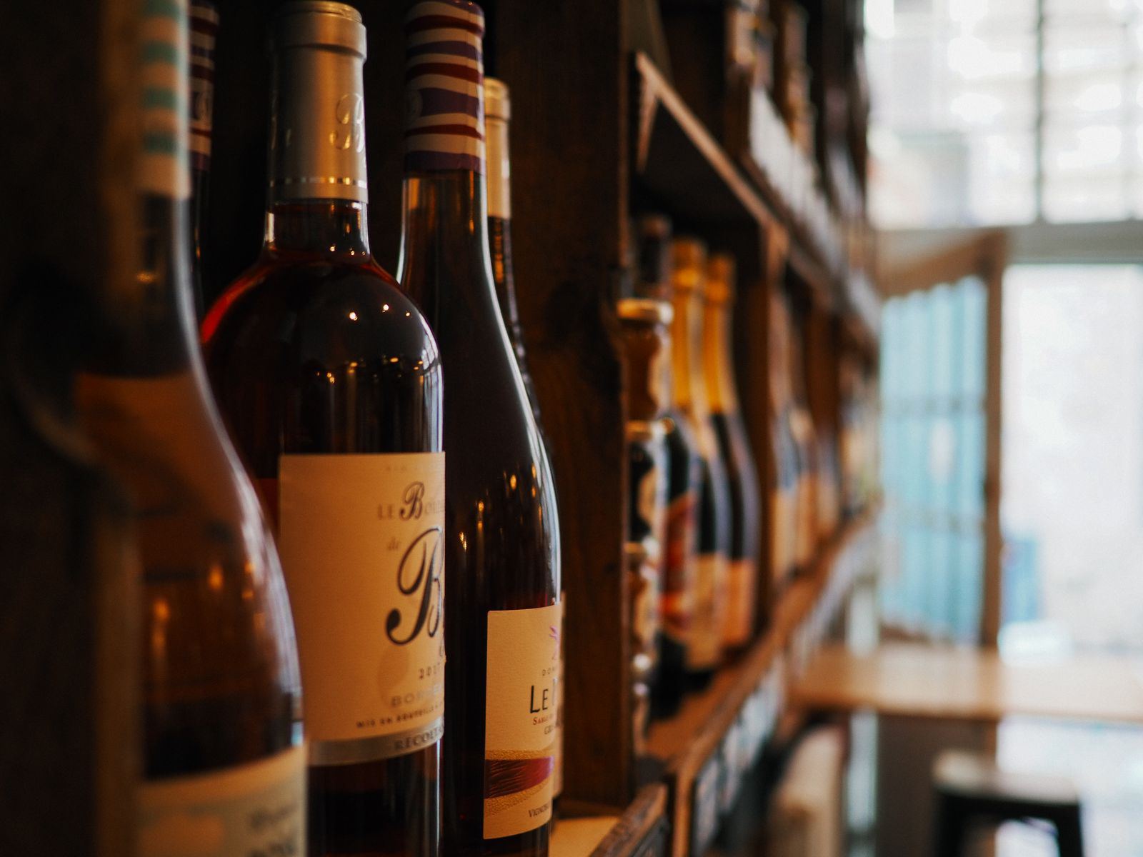 Bottles lined up on the shelf behind the bar